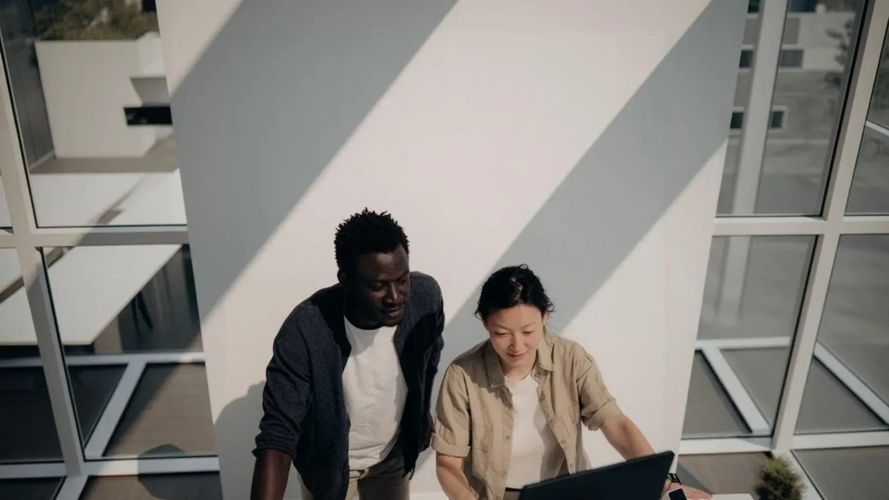 Two collaborators concentrating on the same work, showing chemistry as selective attention and a result neither person could produce alone.
