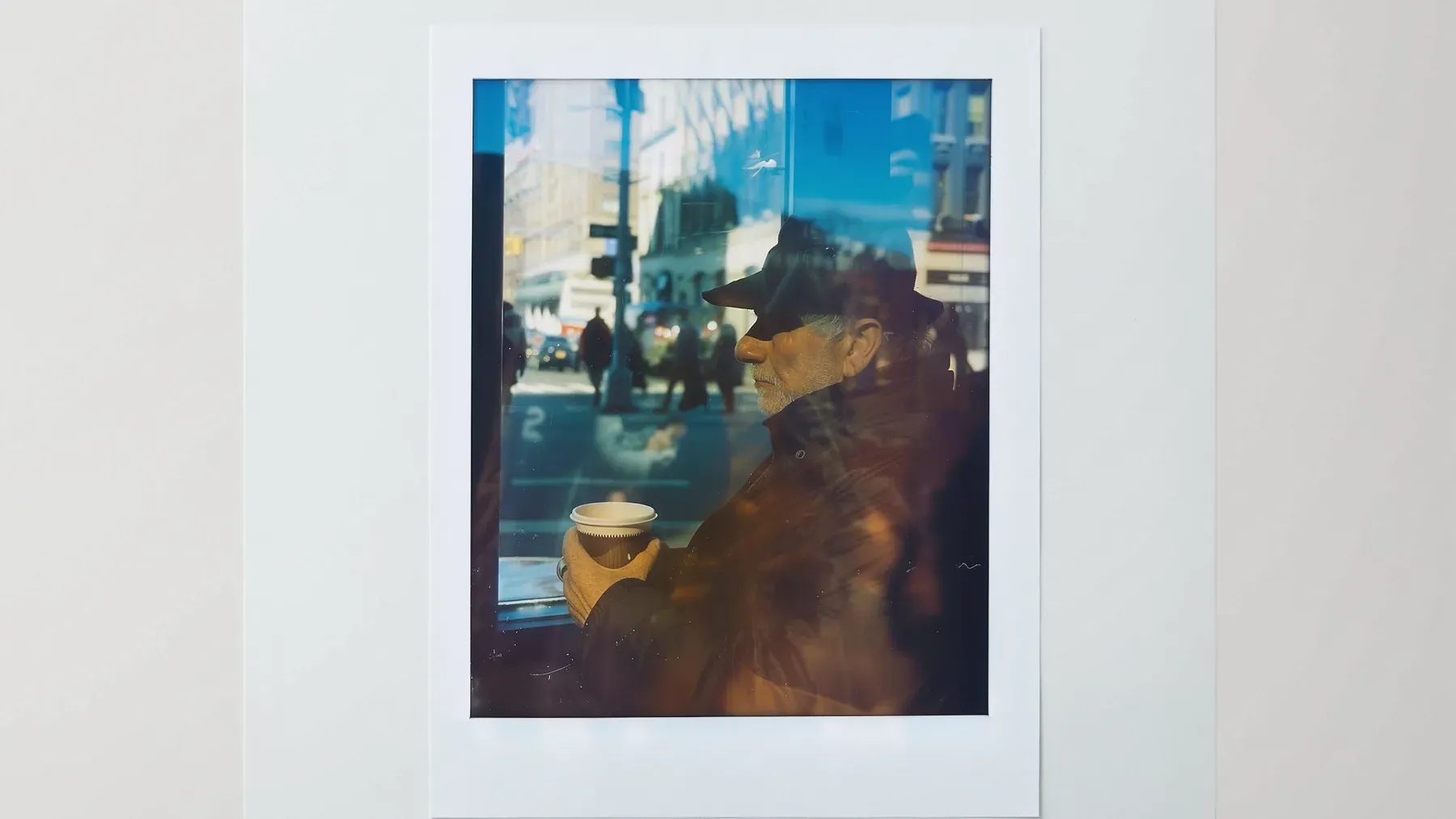 A solitary figure reflected in a window, representing the gap between the identity a character performs and the life he privately knows.