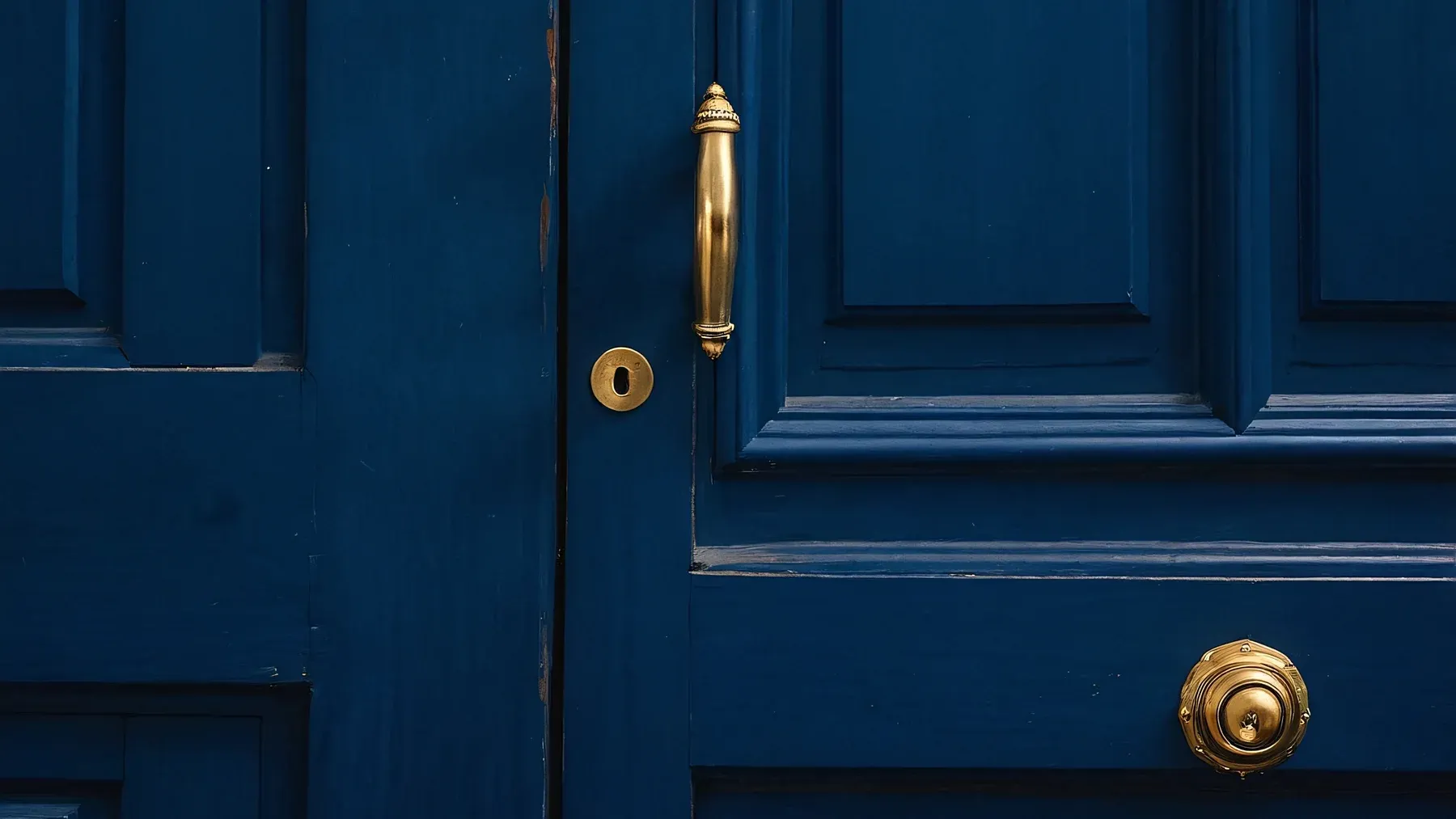 A closed blue door gives the viewpoint character a specific threshold to interpret, approach, or avoid.