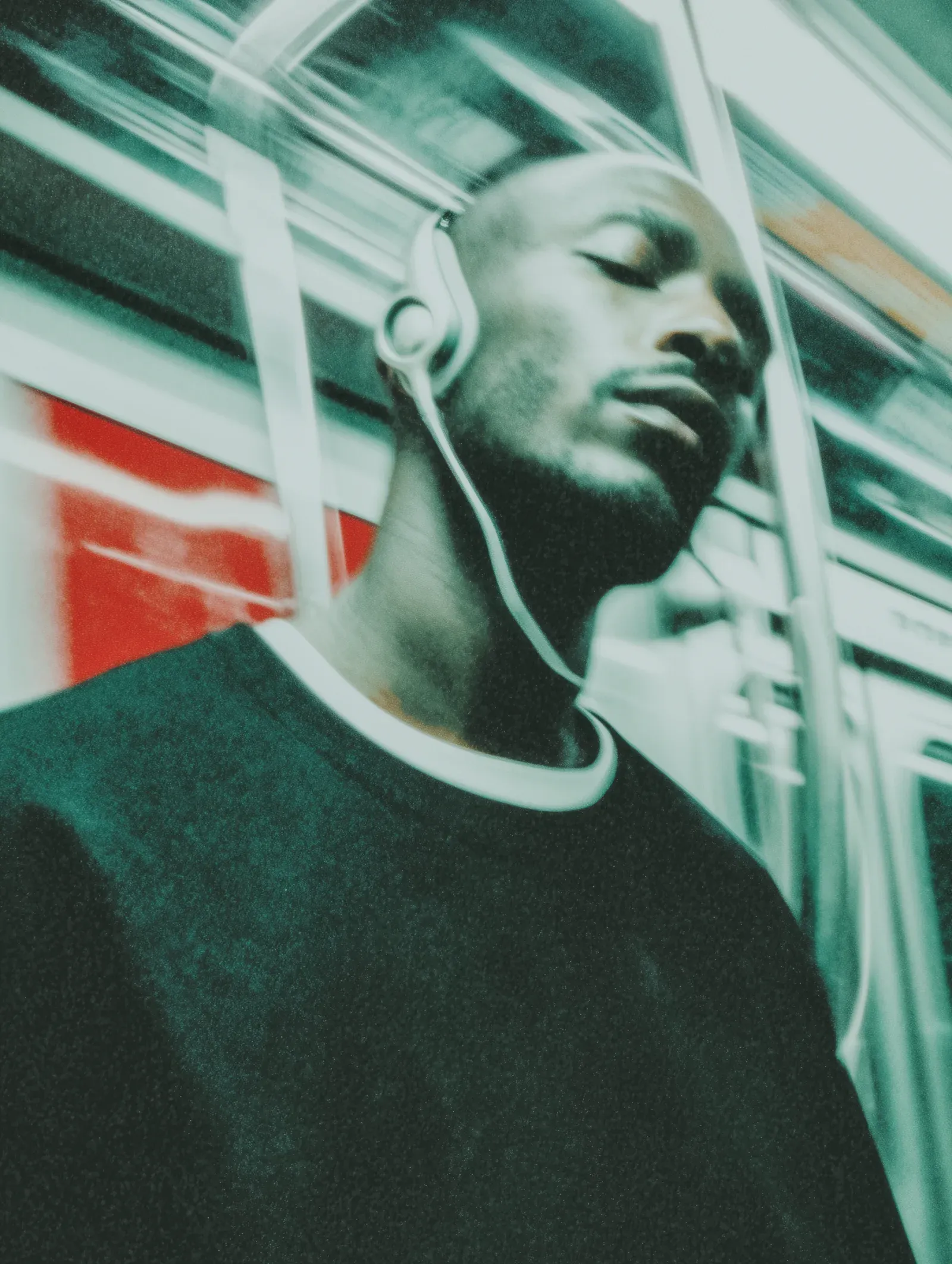 A passenger listening closely through headphones, reflecting the concentration needed to separate source, direction, and pattern from surrounding noise.