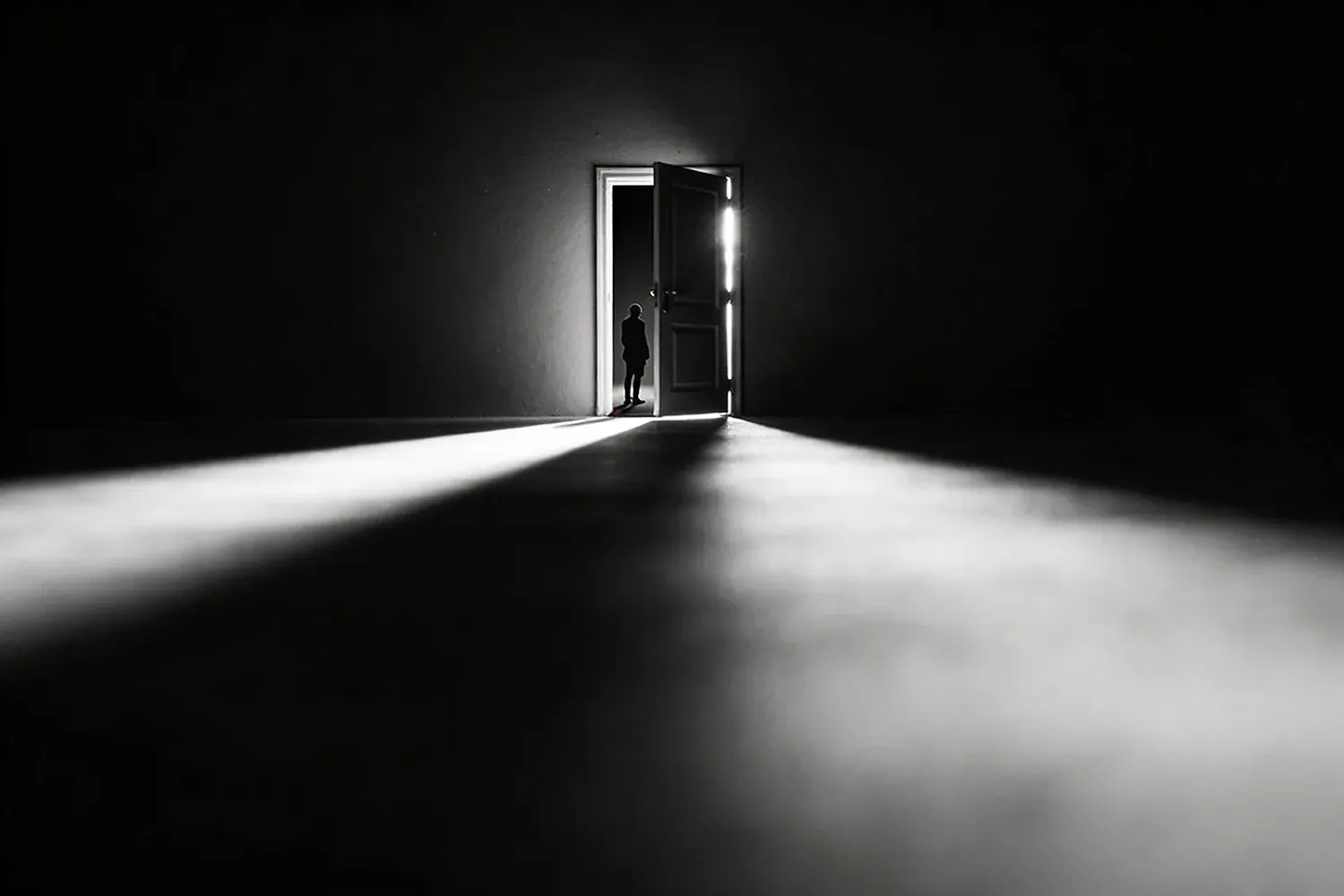 A figure concealed within a dramatic doorway, reflecting how foreshadowing lets the truth enter a scene without fully identifying it.