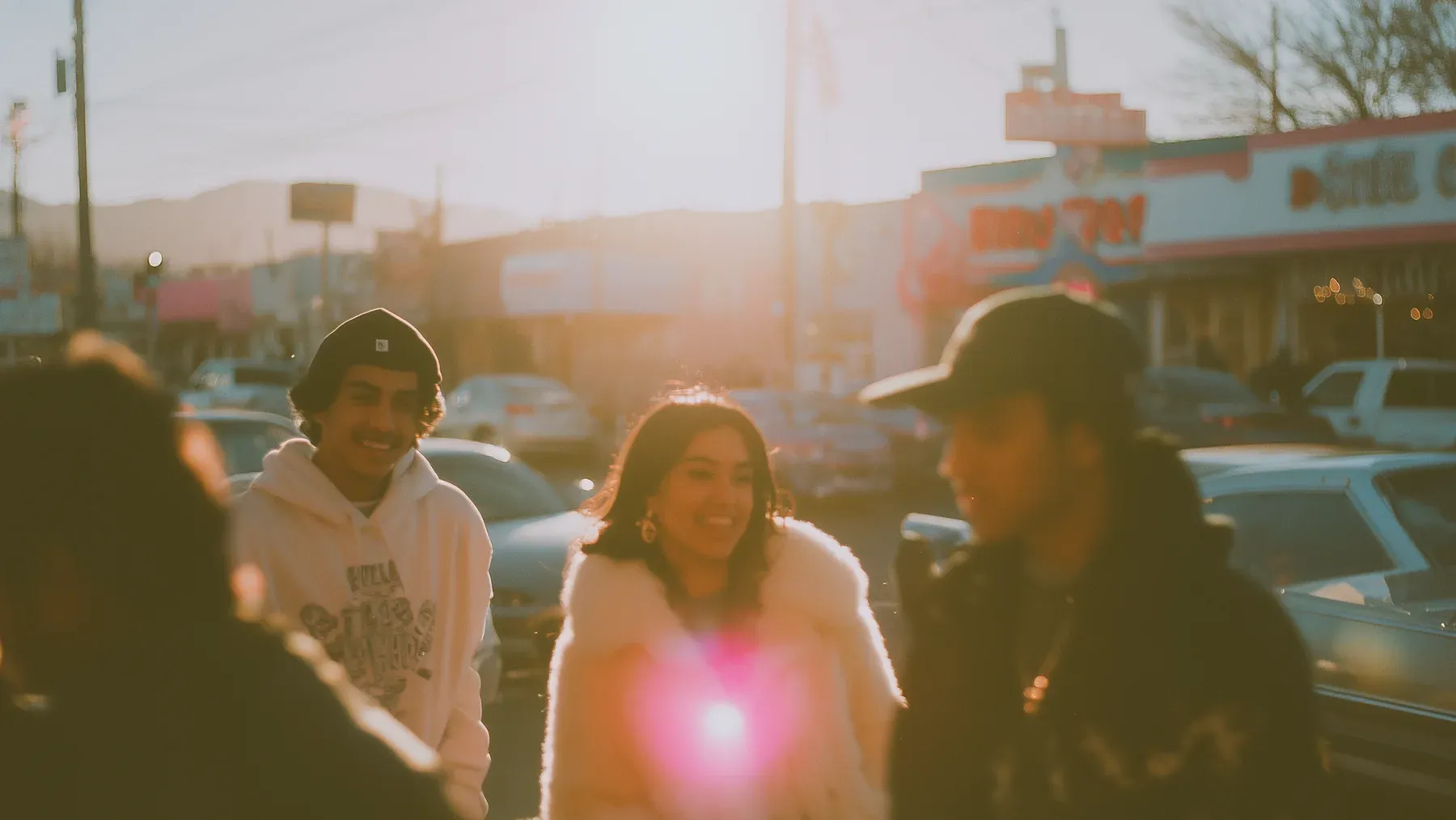 A group of friends walks through a narrow street, showing the social world that continues after one private bond changes shape.