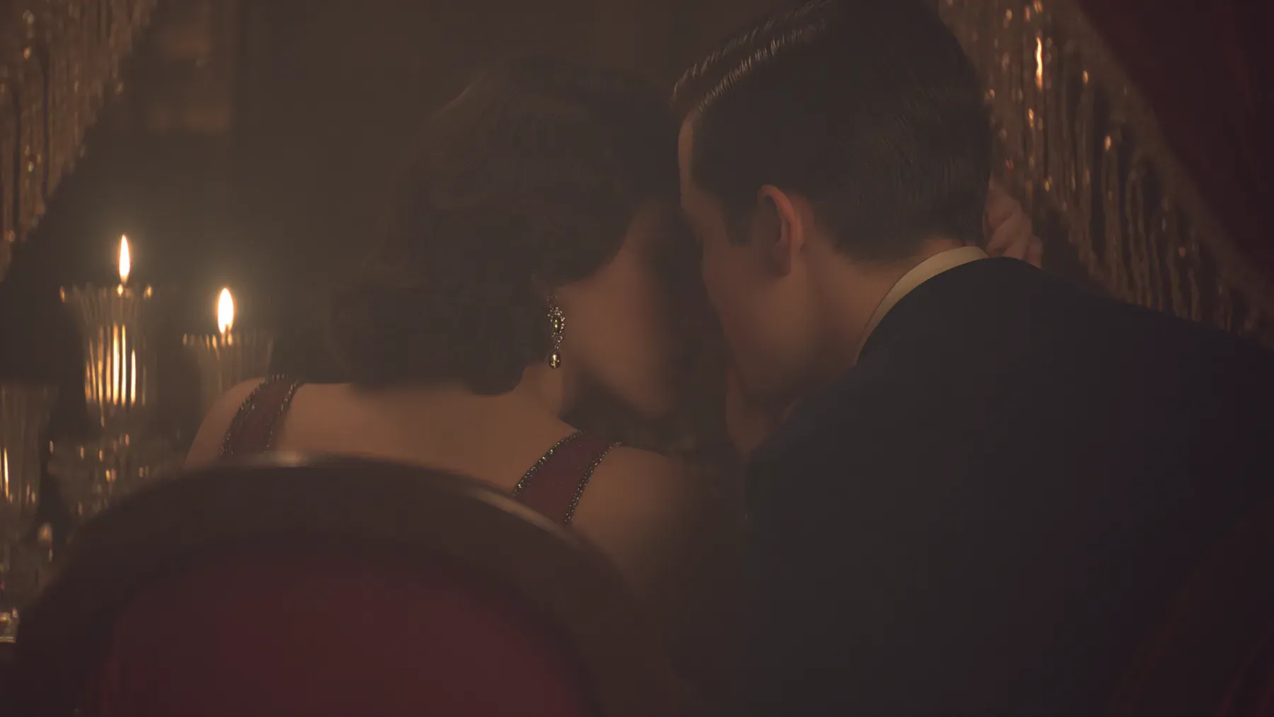 A candlelit couple in period-inspired dress makes attraction feel close, private, and vulnerable to whatever else inhabits the room.