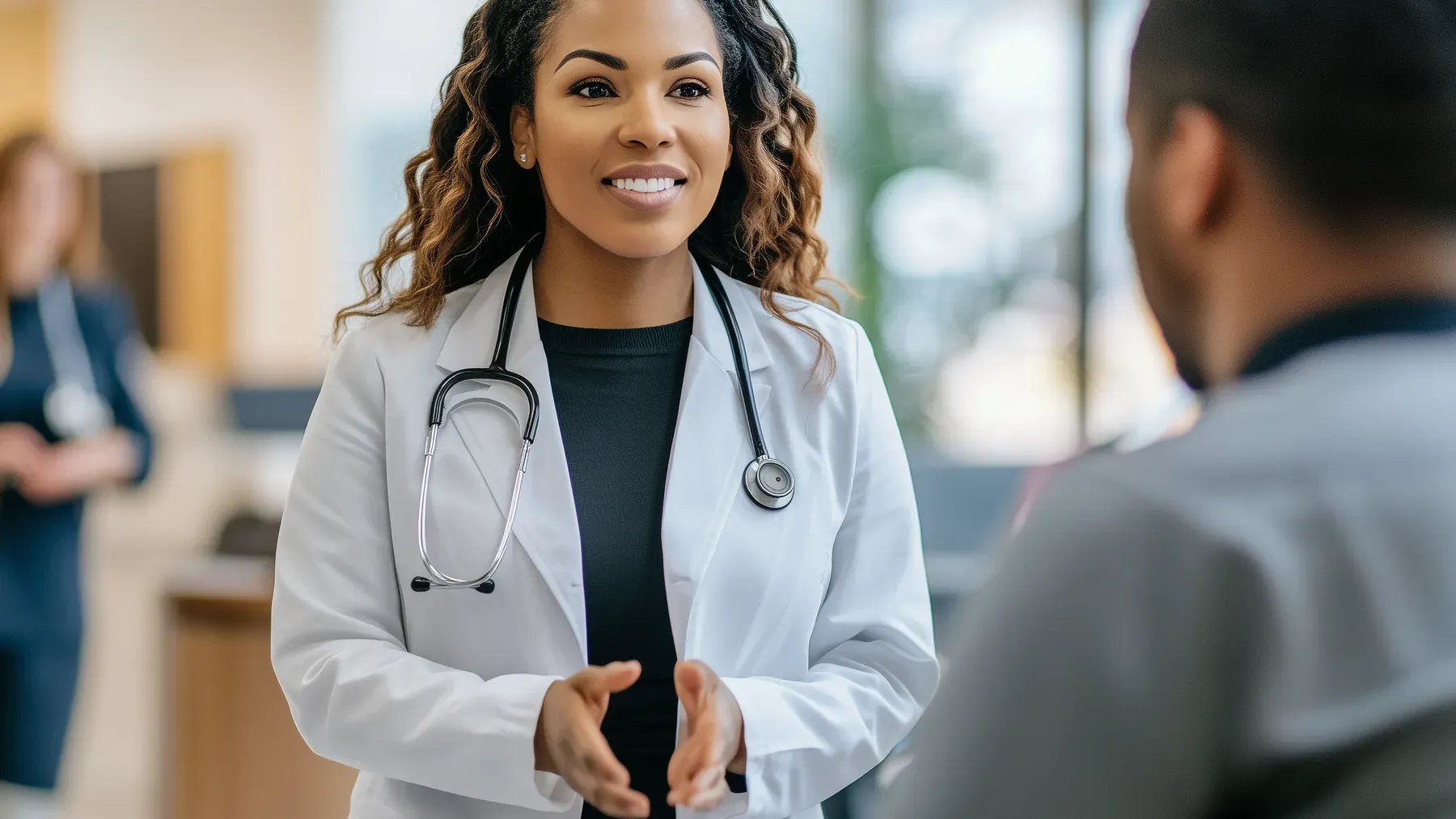 A clinician speaks with a patient, a reminder that medical information belongs inside a relationship shaped by consent, uncertainty, and professional responsibility.