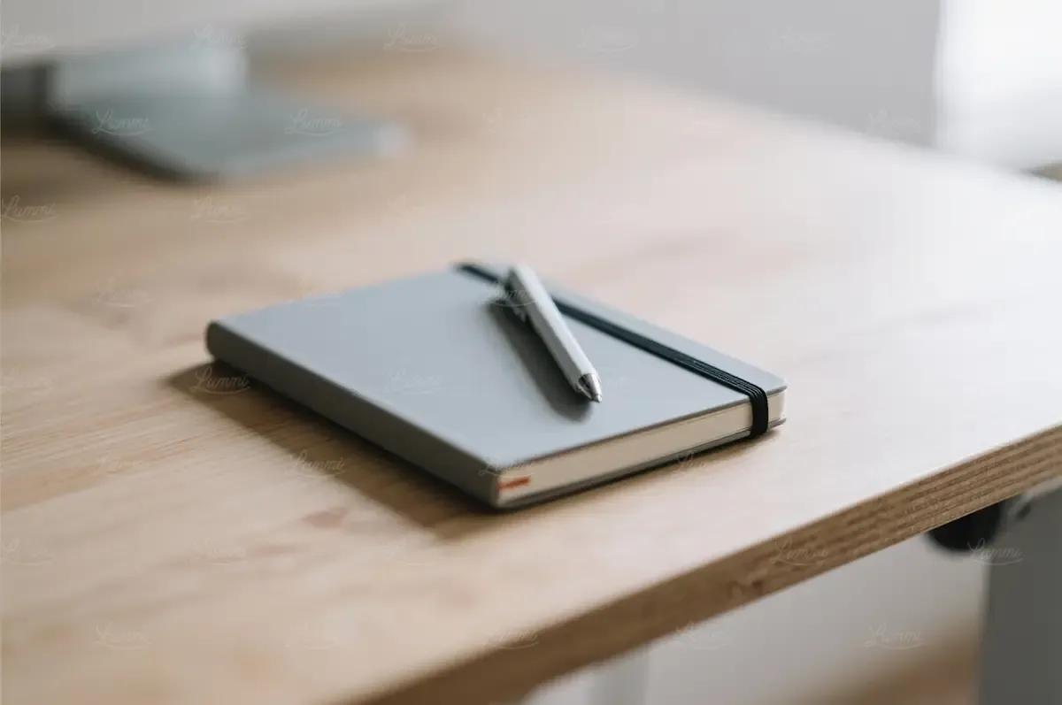 A blank first page on a desk, the empty space a novel is about to fill.