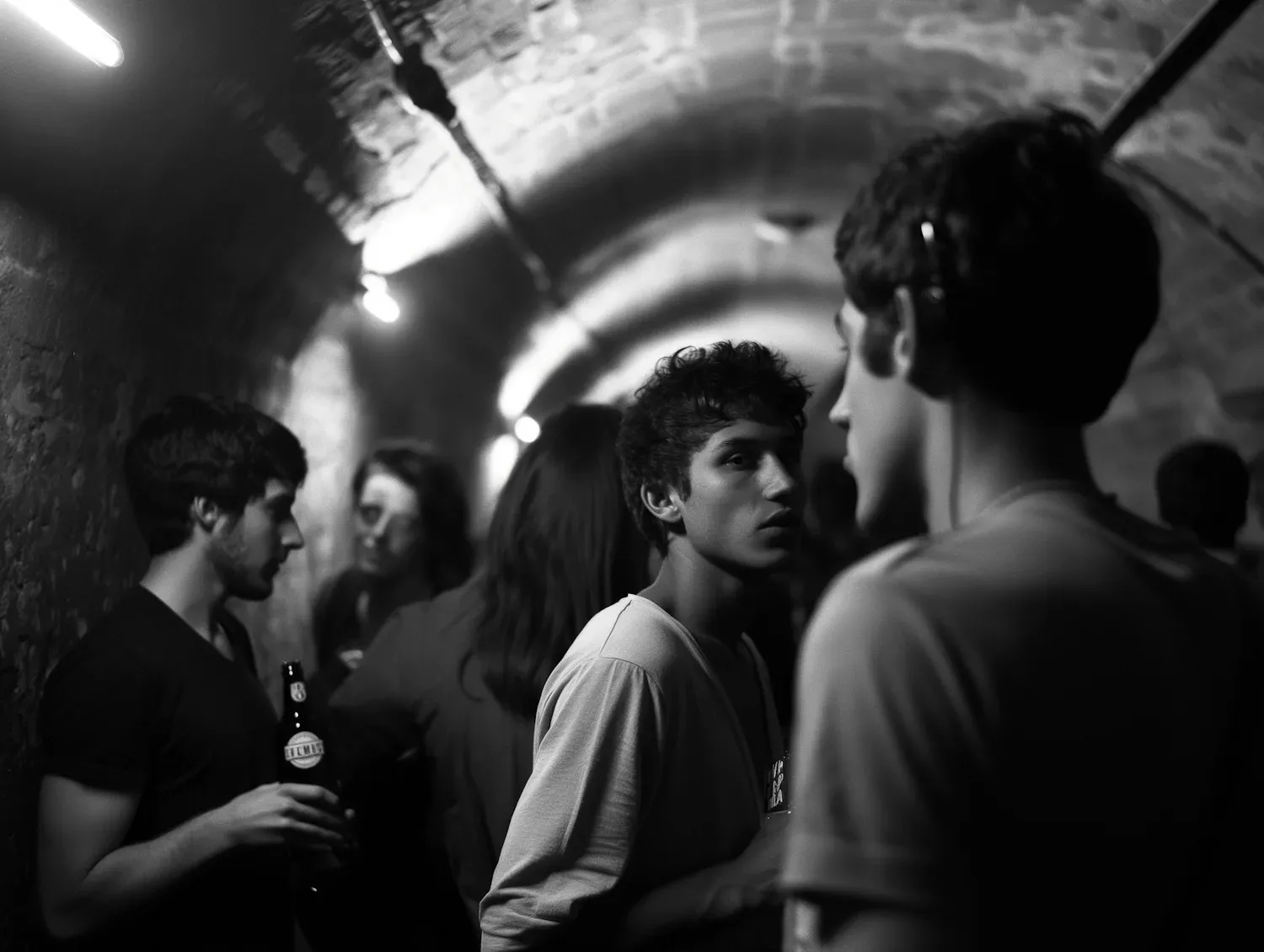 A crowded group scene in black and white, illustrating how attention and hierarchy matter when multiple people are talking at once.