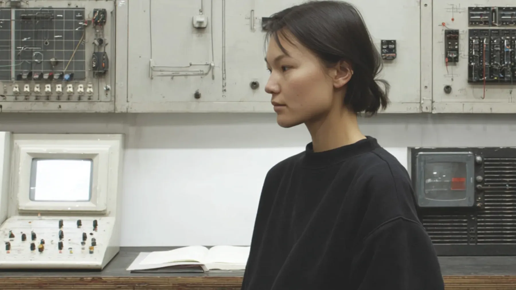 An operator holding attention between private inference and live control-room evidence.