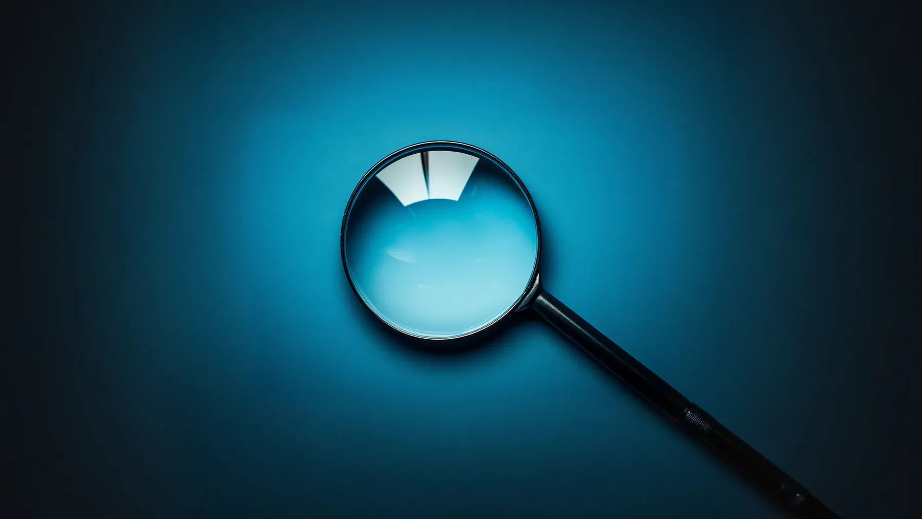 A magnifying glass isolated against blue, representing the focused test that distinguishes one explanation from its competitors.
