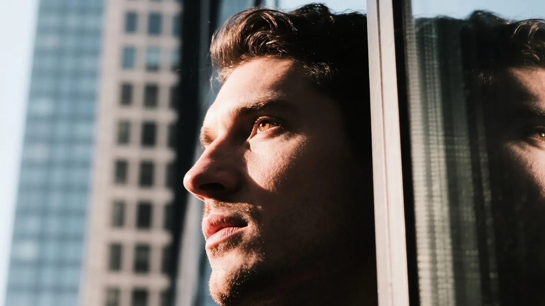 A face meeting its reflection in glass, suggesting the interpretive filter between an event and the meaning a viewpoint character assigns to it.