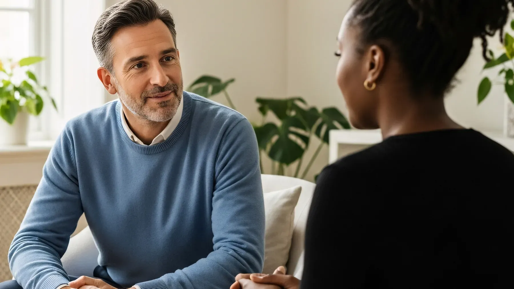 Two people in a focused conversation illustrate how a dialogue hook becomes legible through the first speaker's action and the listener's reply.