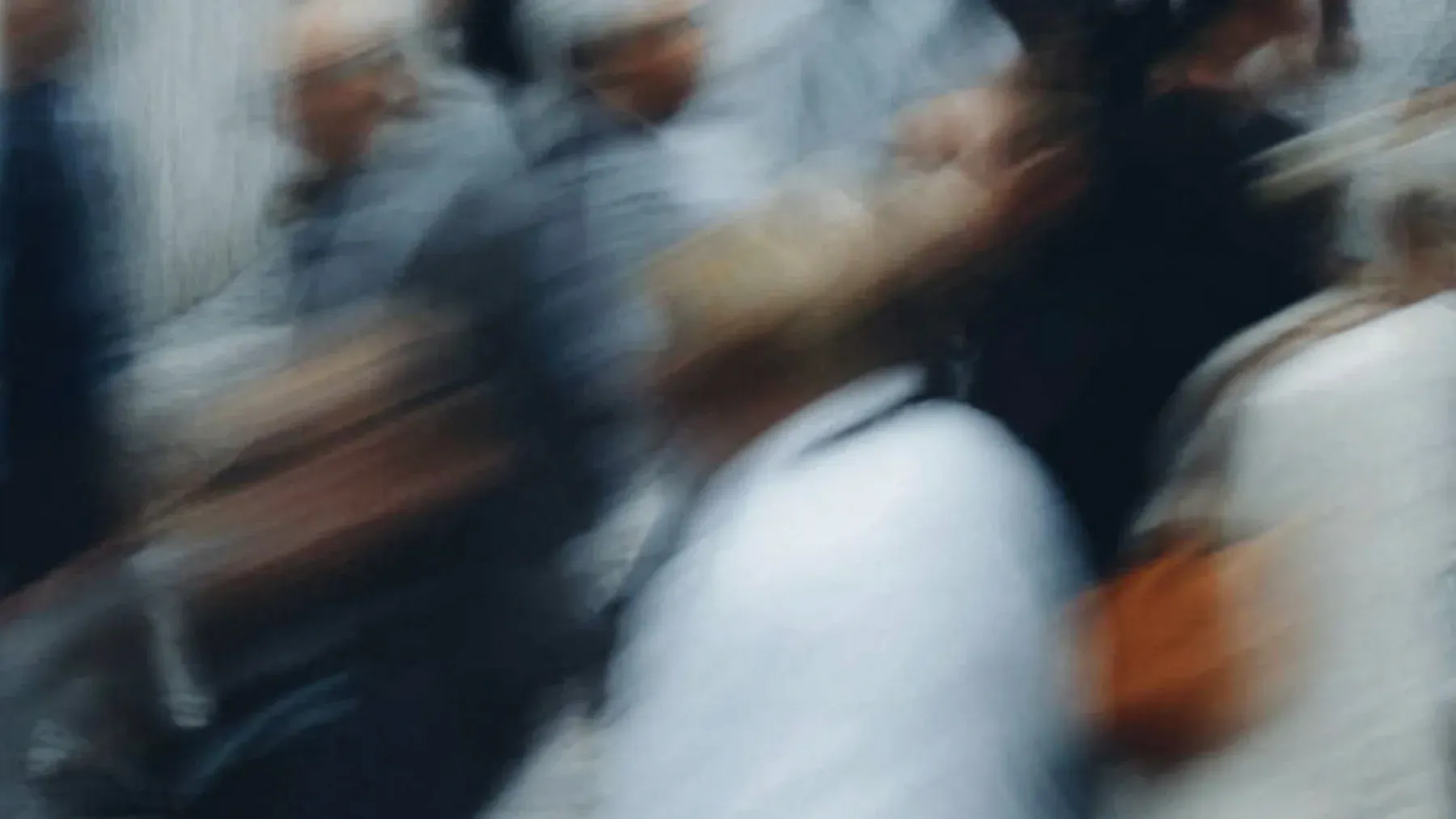 A moving city crowd seen as a shared pattern, representing the many private lives an omniscient narrator can perceive while selecting only those that shape the scene.