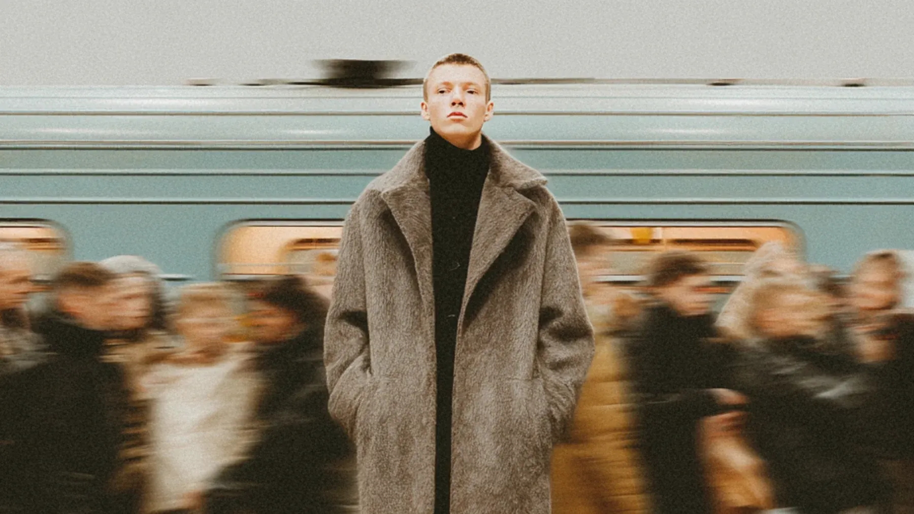 A commuter standing still while a subway and crowd move behind them, an image of the competing body, interpretation, and story clocks inside a panic scene.