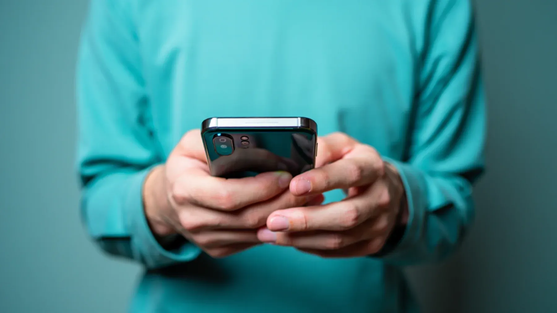 Hands holding a phone, showing how a small prearranged message can preserve choice when speaking or composing a full explanation becomes difficult.