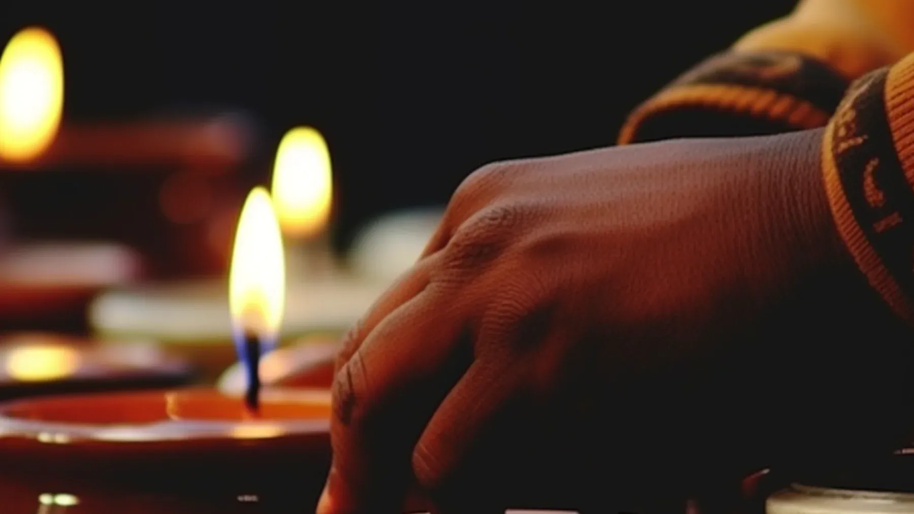 A hand moving among candlelit vessels, representing ritual interpretation as an action performed by people with authority, habits, and consequences.