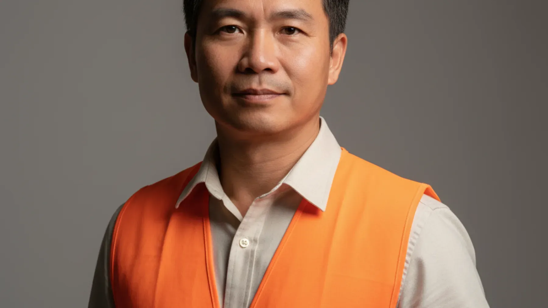 A safety professional holding technical plans, representing evidence that supports an innocent explanation before the reveal and a fuller causal history afterward.