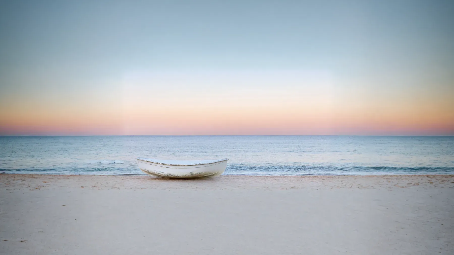 A weathered boat resting alone on a beach, representing transport, shelter, evidence, and authority after the voyage has ended.