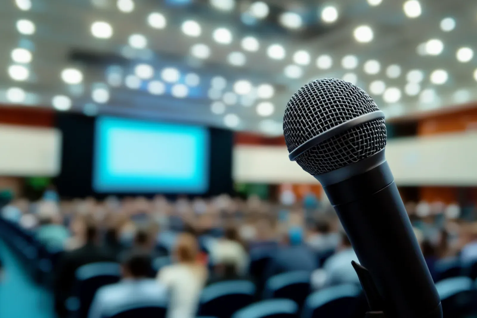 A microphone waiting in a conference room where a concise novel pitch must leave time for a real conversation.