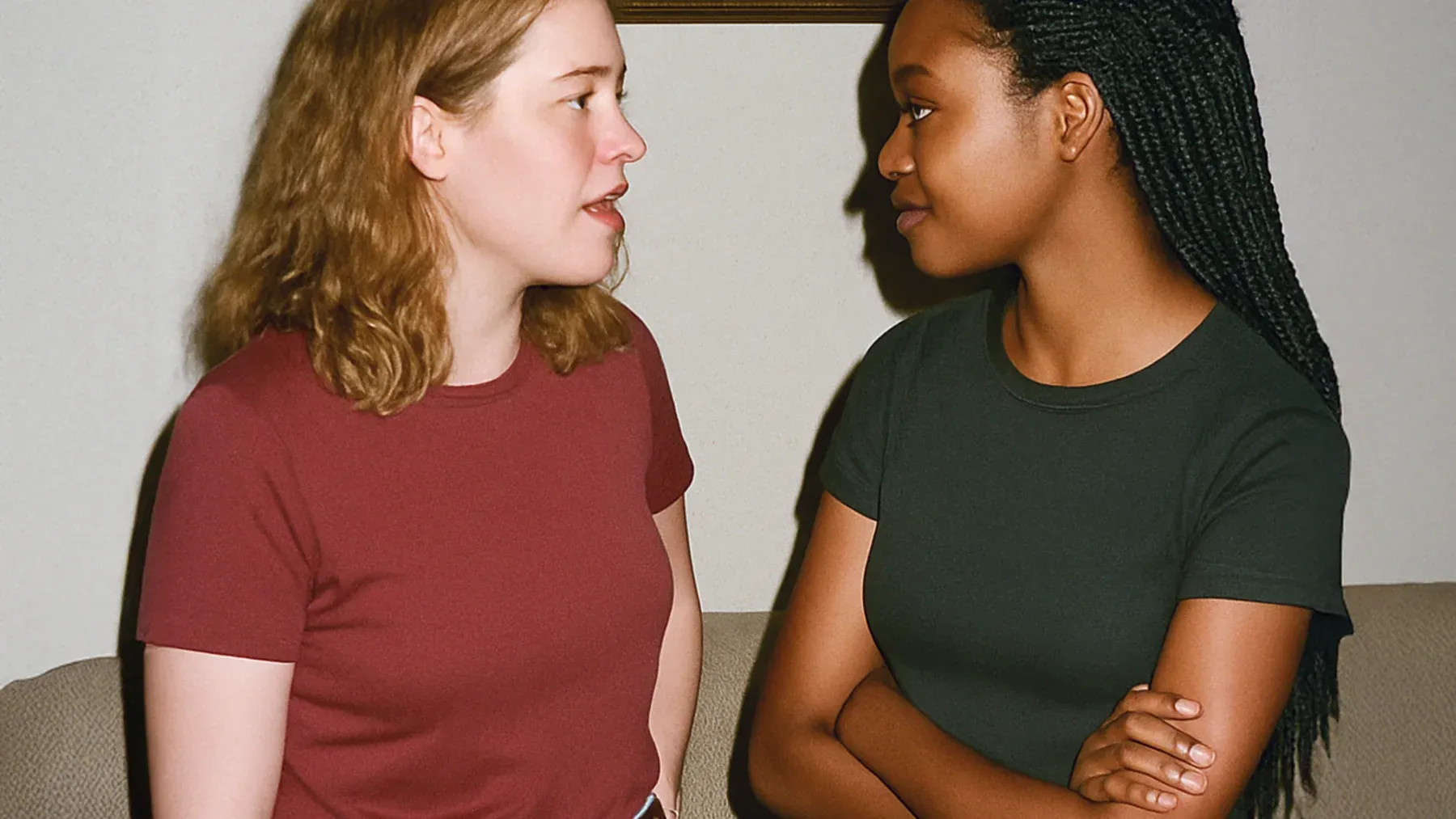 Two adults facing each other in a family room make the present disagreement feel intimate, practiced, and difficult to leave.
