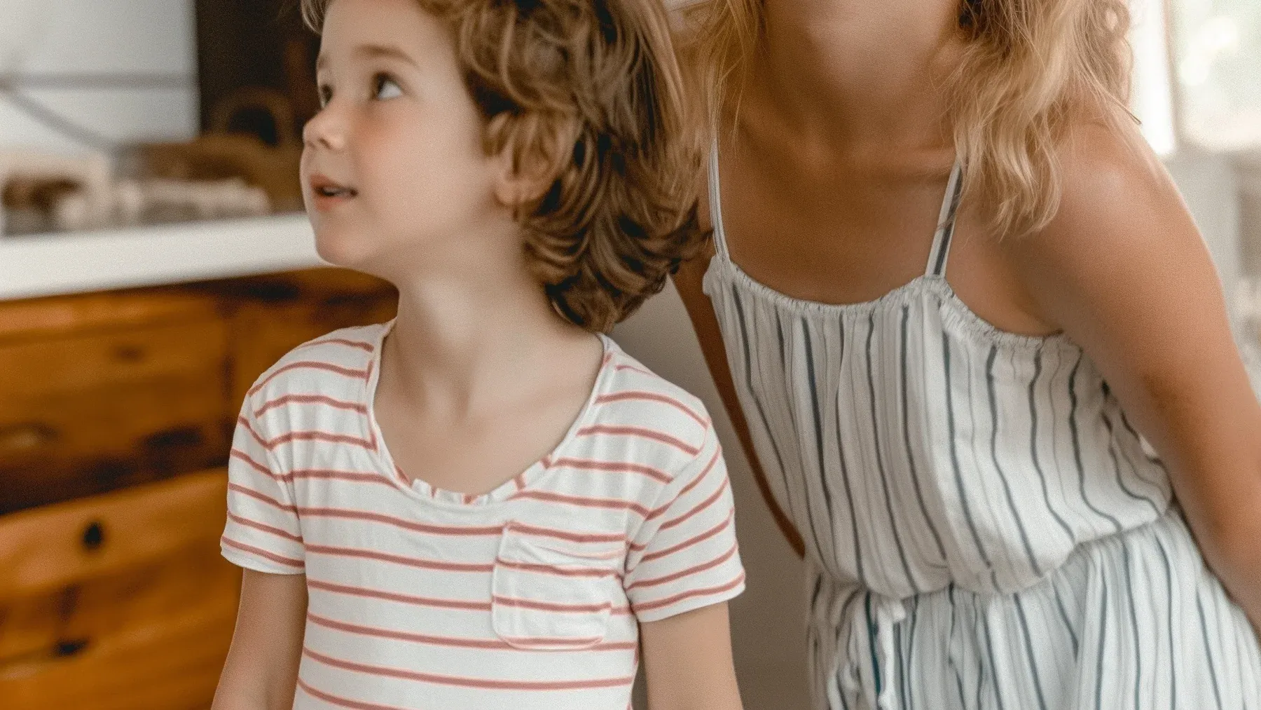 Two siblings looking upward together recalls the moments of shared attention that can survive beneath an adult rivalry.