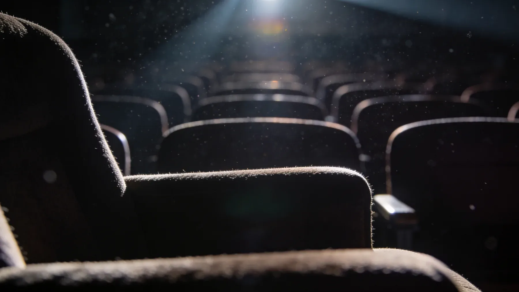 A theater stage waiting under work lights, where a fixed opening time turns technical decisions into story pressure.