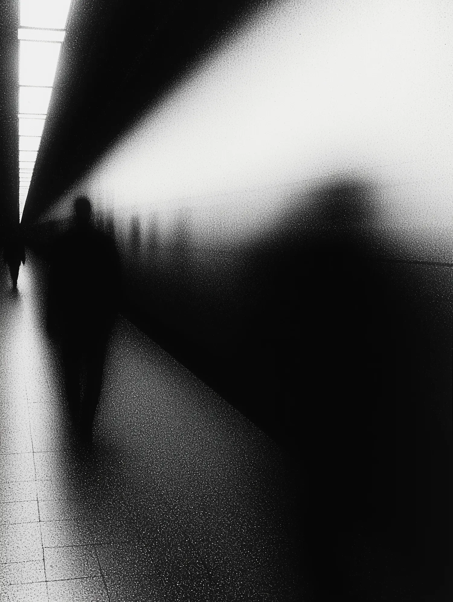 A blurred figure moving through a shadowed corridor, suggesting how partial information can reveal motion without revealing safety or intent.