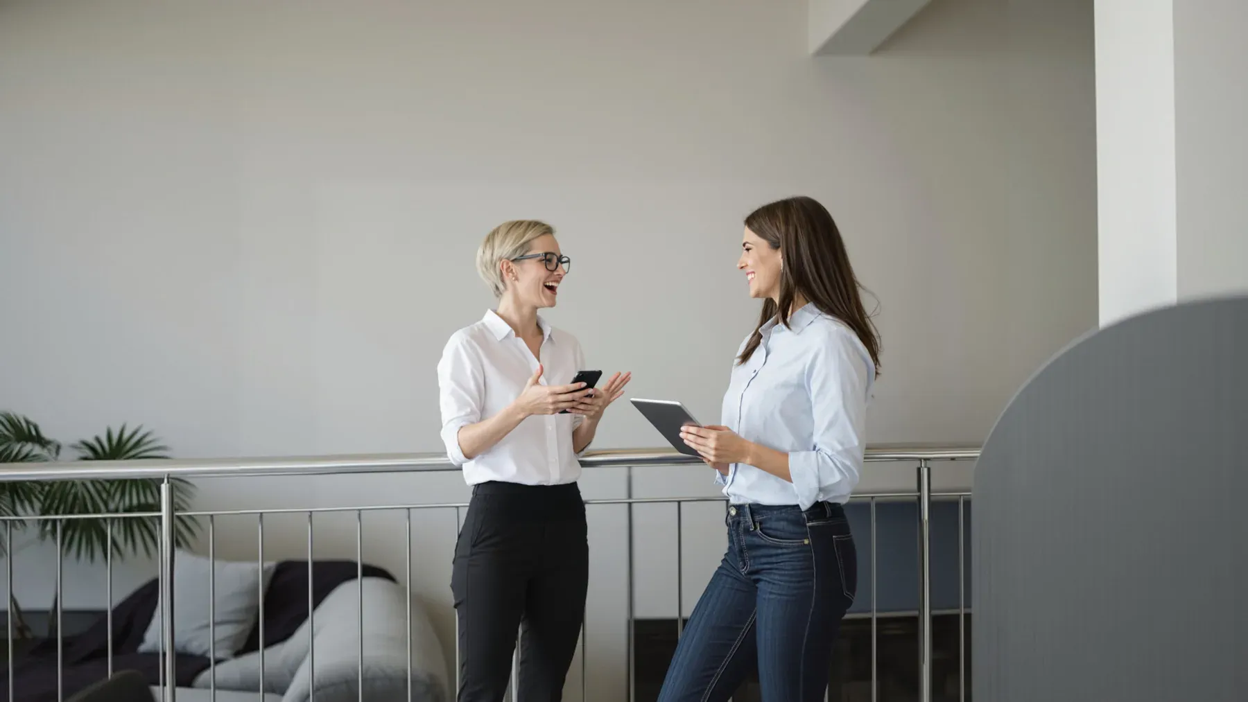 Two professionals talking in a bright workplace, capturing the ease and risk of intimacy growing inside ordinary work.